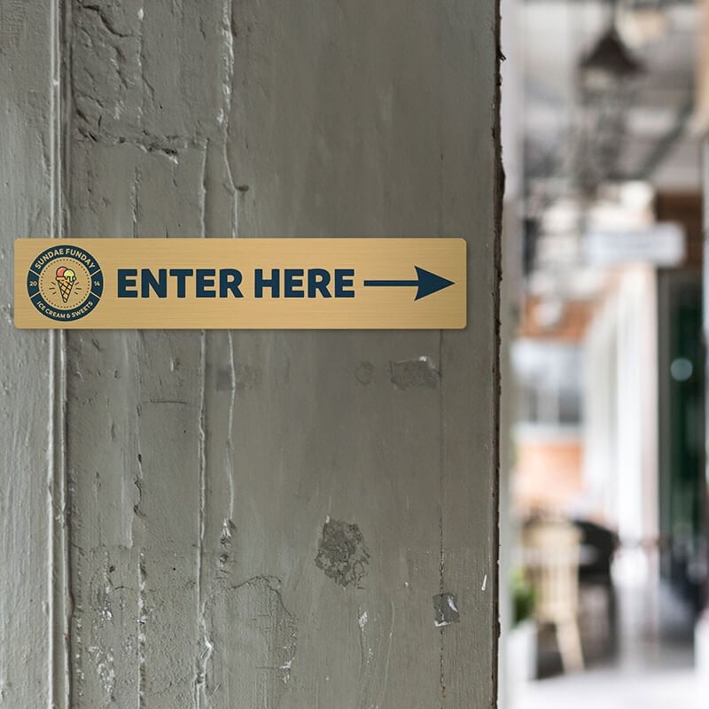 4x20 printed brass sign displayed by an entrance 4x20 printed brass sign displayed by an entrance