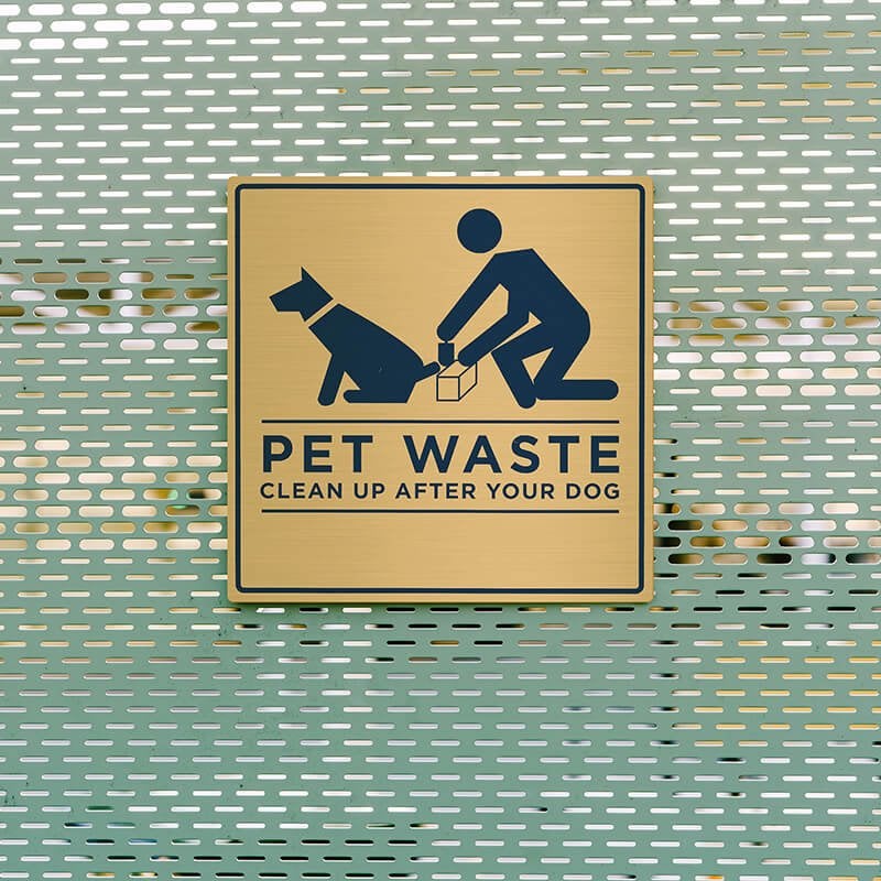 4x4 printed brass sign displayed on a fence