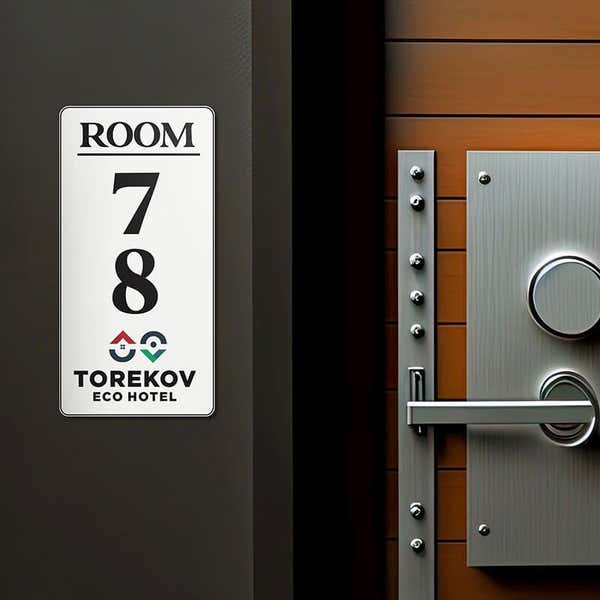 6" x 3" custom plastic sign displayed next to a room