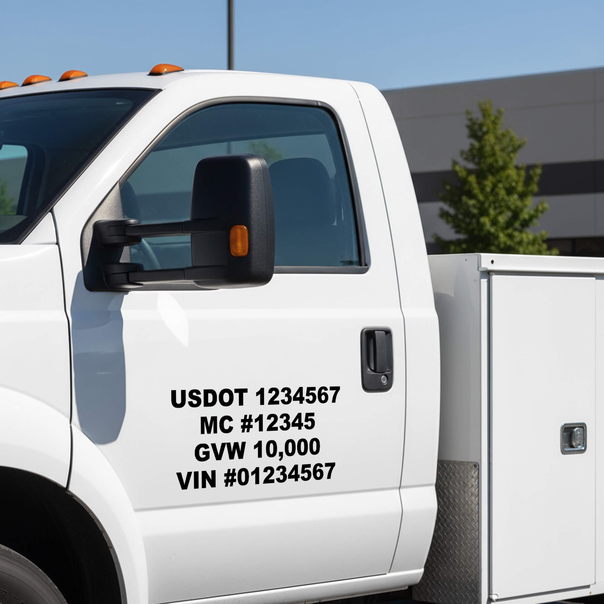 Vinyl decals of identification numbers on the side of a white truck