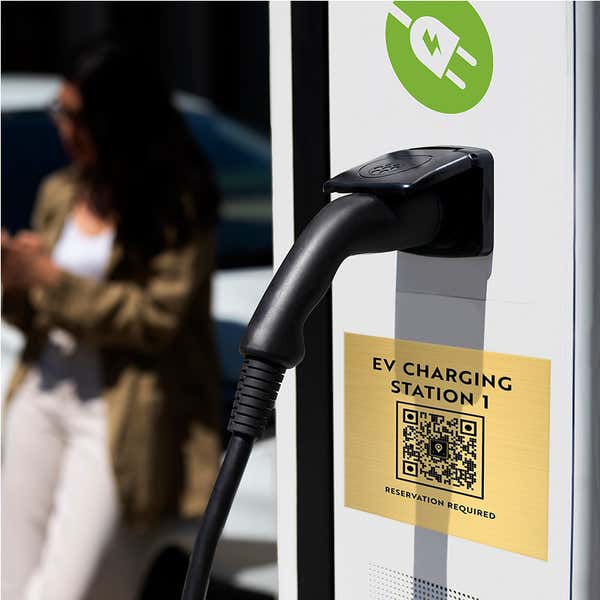 Engraved Brass Sign with a QR Code Posted on an EV Charging Station 