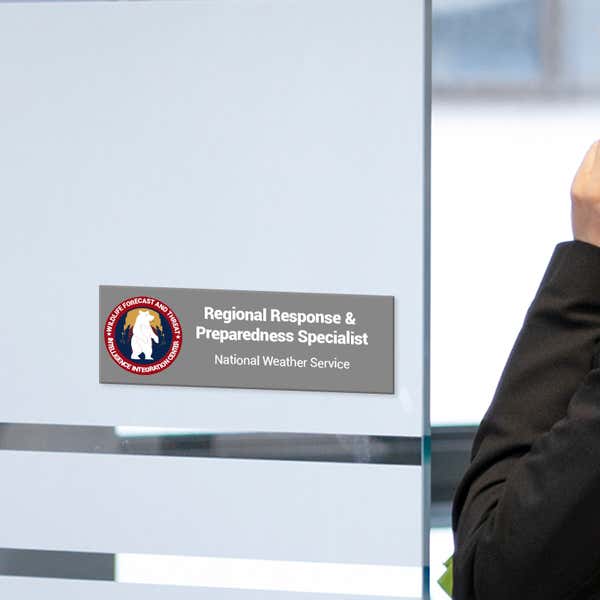 A Gray Plastic Sign With a Colorful Logo and Says Regional Response and Preparedness Specialist