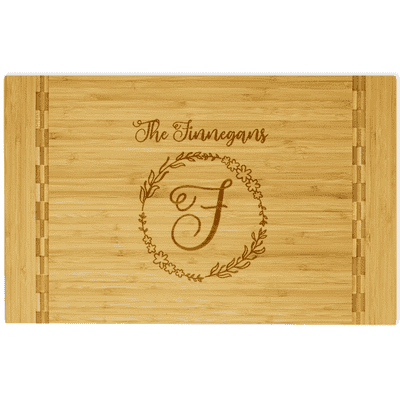 Wooden cutting board with block inlay engraved with wreath and family name