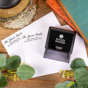 Overhead shot of Jenson Family Handwritten Address Stamp Impression on two envelopes next to stamp body