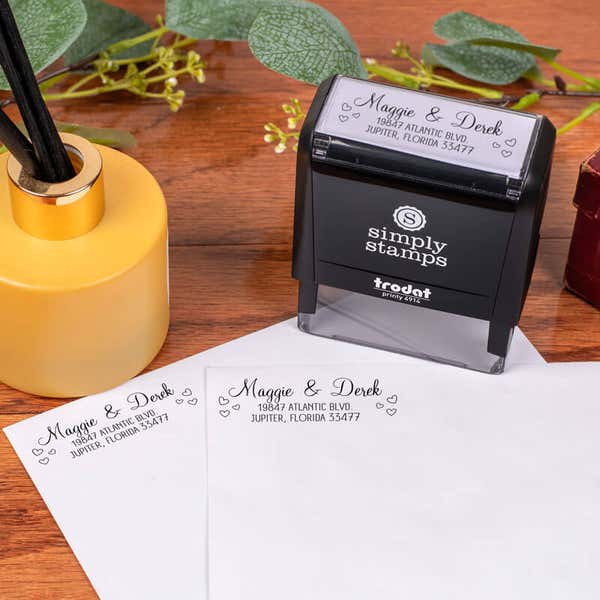 Couple Hearts Handwritten Address Stamp design impression on two envelopes next to self inking stamp body
