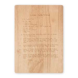 Maple cutting board engraved with a handwritten Irish Soda Bread recipe, featuring neat script text centered on the board against a light wood grain background.