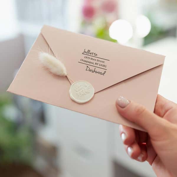 Davenport Offset Address Stamp Impression on envelope in person's hand