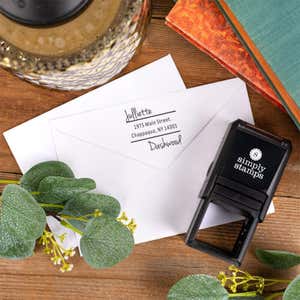 Davenport Offset Address Self Inking Stamp body next to stamp impression on envelope flat lay
