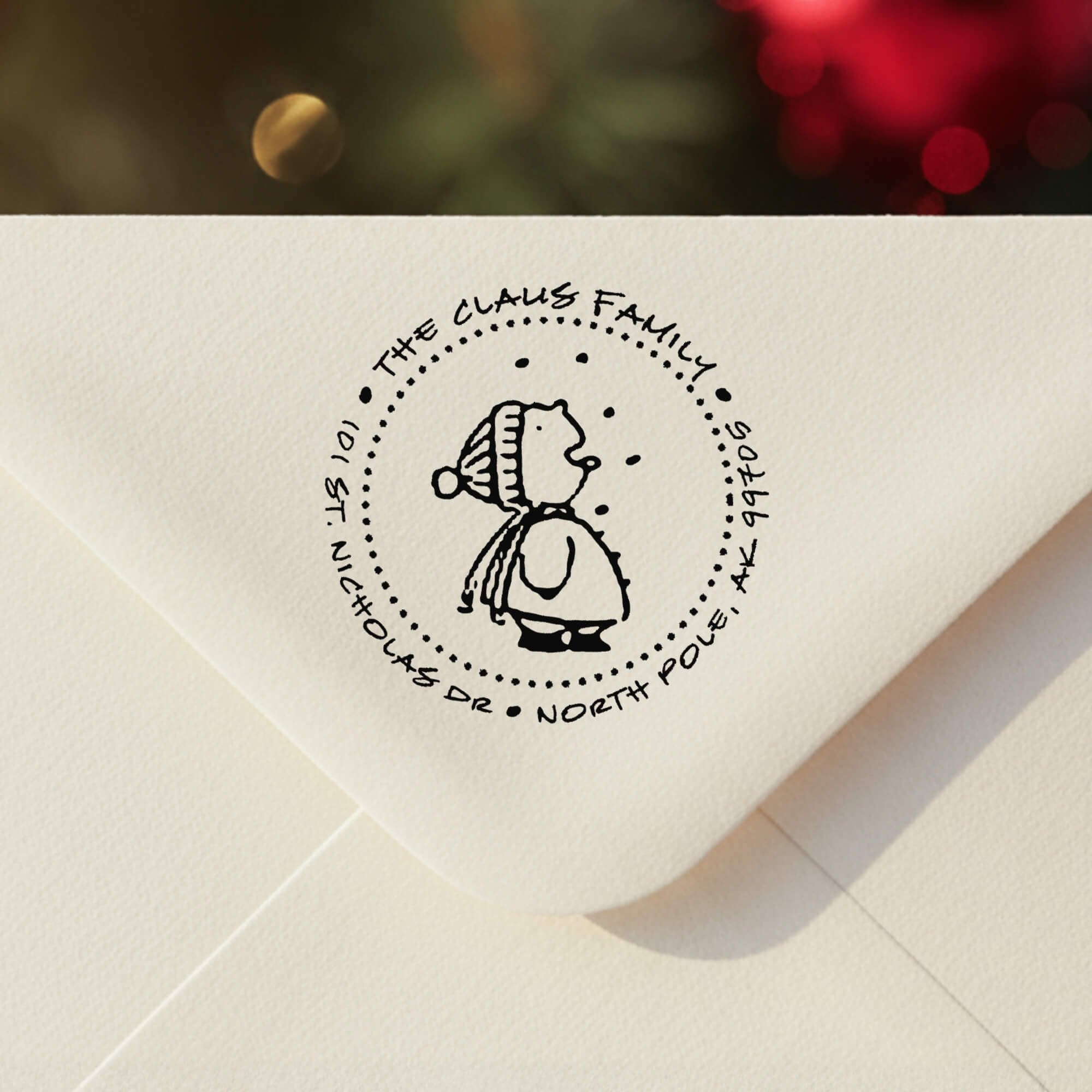 Personalized ‘Cute Snowflake Catcher’ address stamp impression on envelope flap for holiday cards.