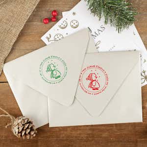 Green and red ink impressions of ‘Cute Snowflake Catcher’ return address stamp on Christmas envelopes.