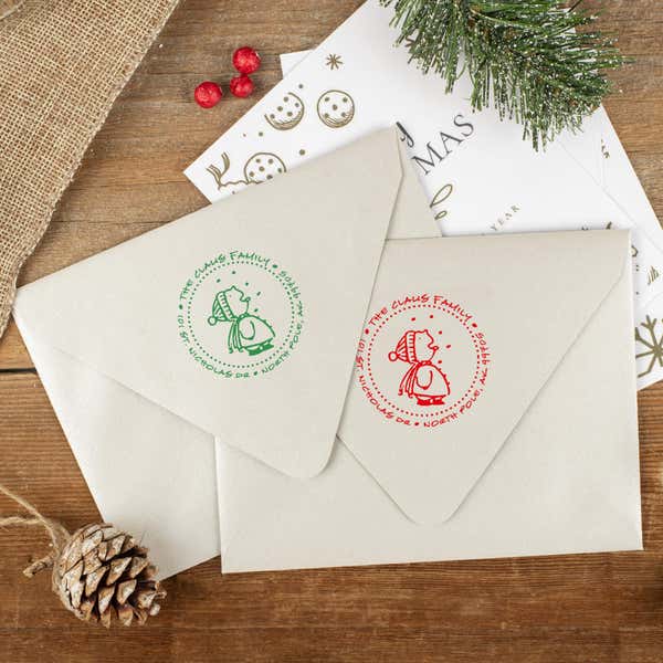 Green and red ink impressions of ‘Cute Snowflake Catcher’ return address stamp on Christmas envelopes.