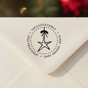 Personalized round ‘Holiday Star’ address stamp impression on envelope flap for holiday cards.