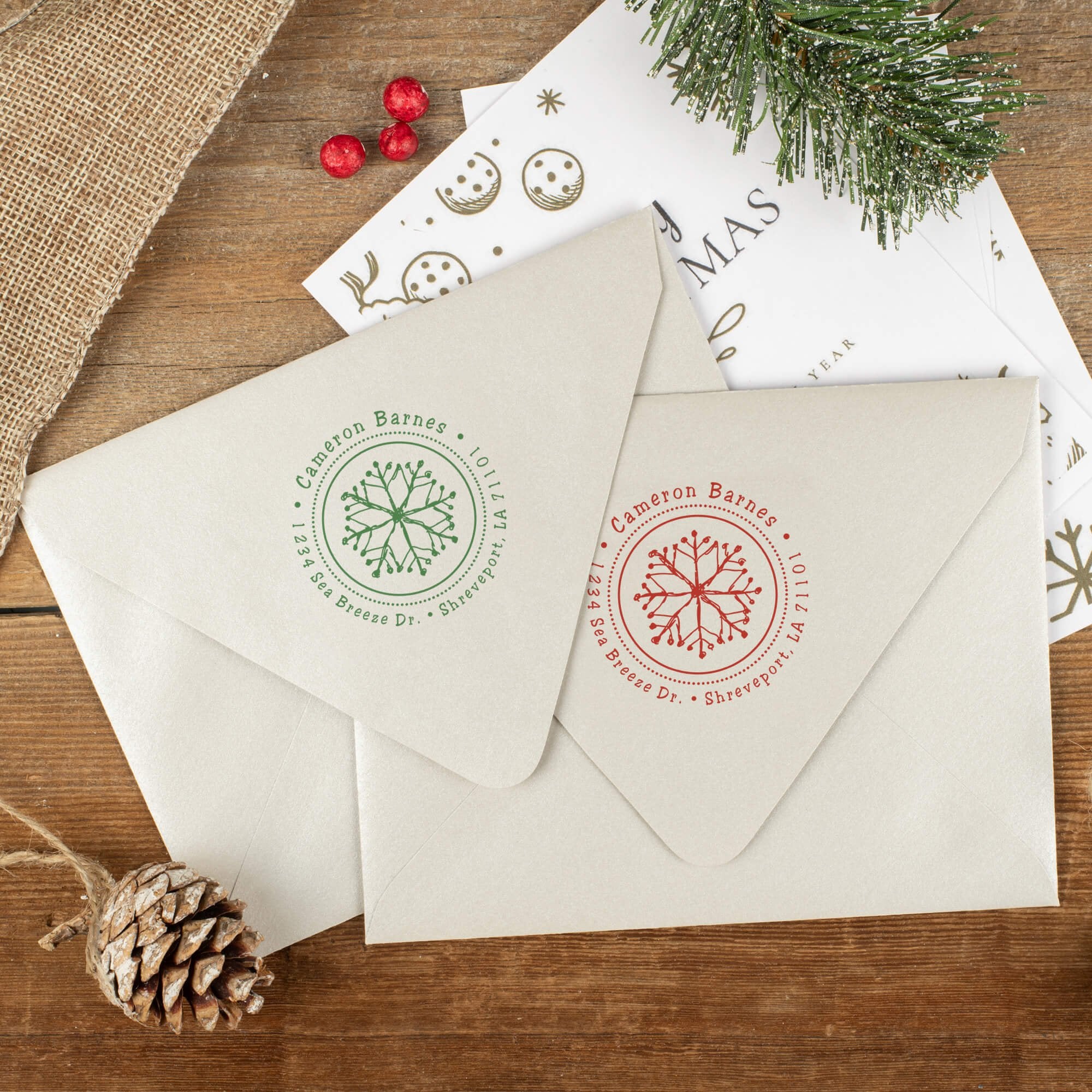 Green and red ink impressions of ‘Hand Drawn Snowflake’ return address stamp on Christmas envelopes.