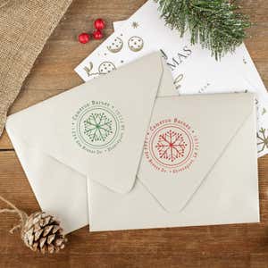 Green and red ink impressions of ‘Hand Drawn Snowflake’ return address stamp on Christmas envelopes.