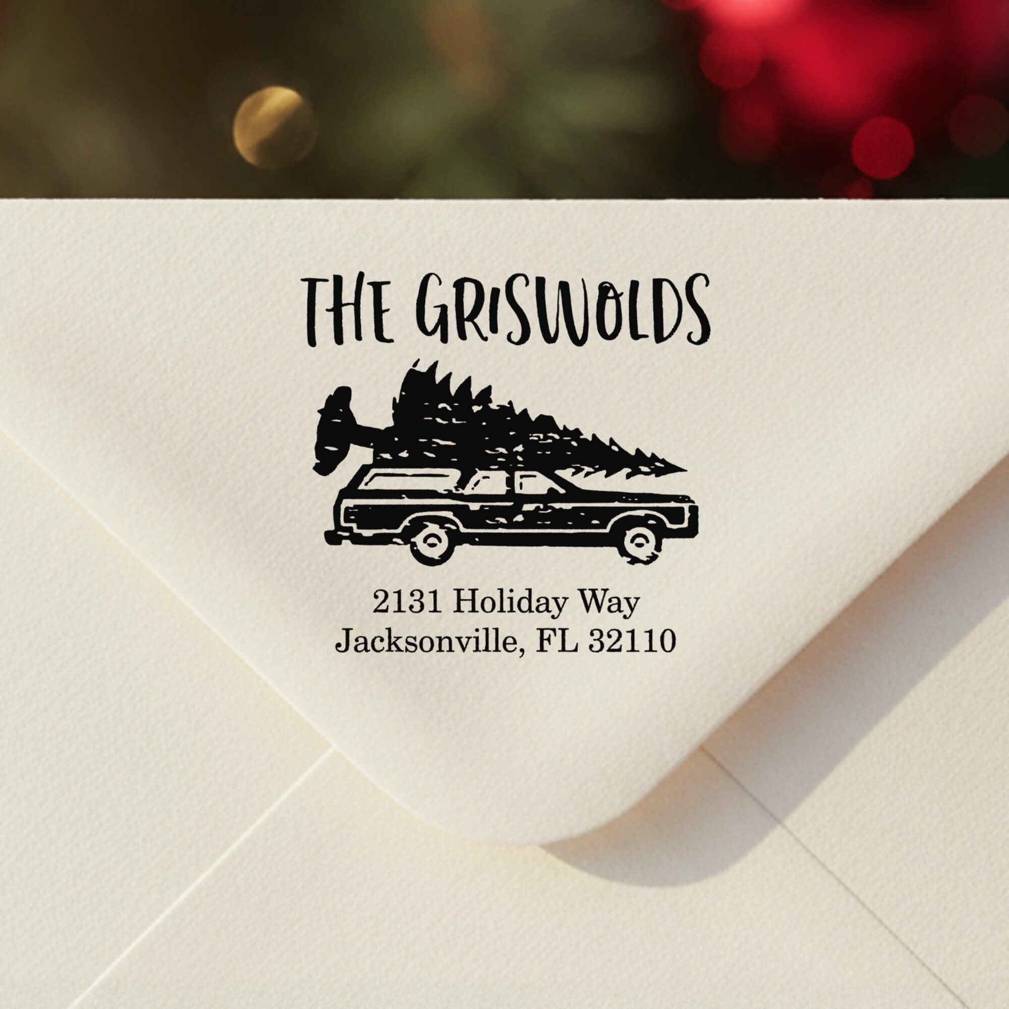 Personalized ‘Griswold Holiday’ address stamp impression on envelope flap for holiday cards.