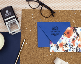 custom return address stamp on desk with envelope